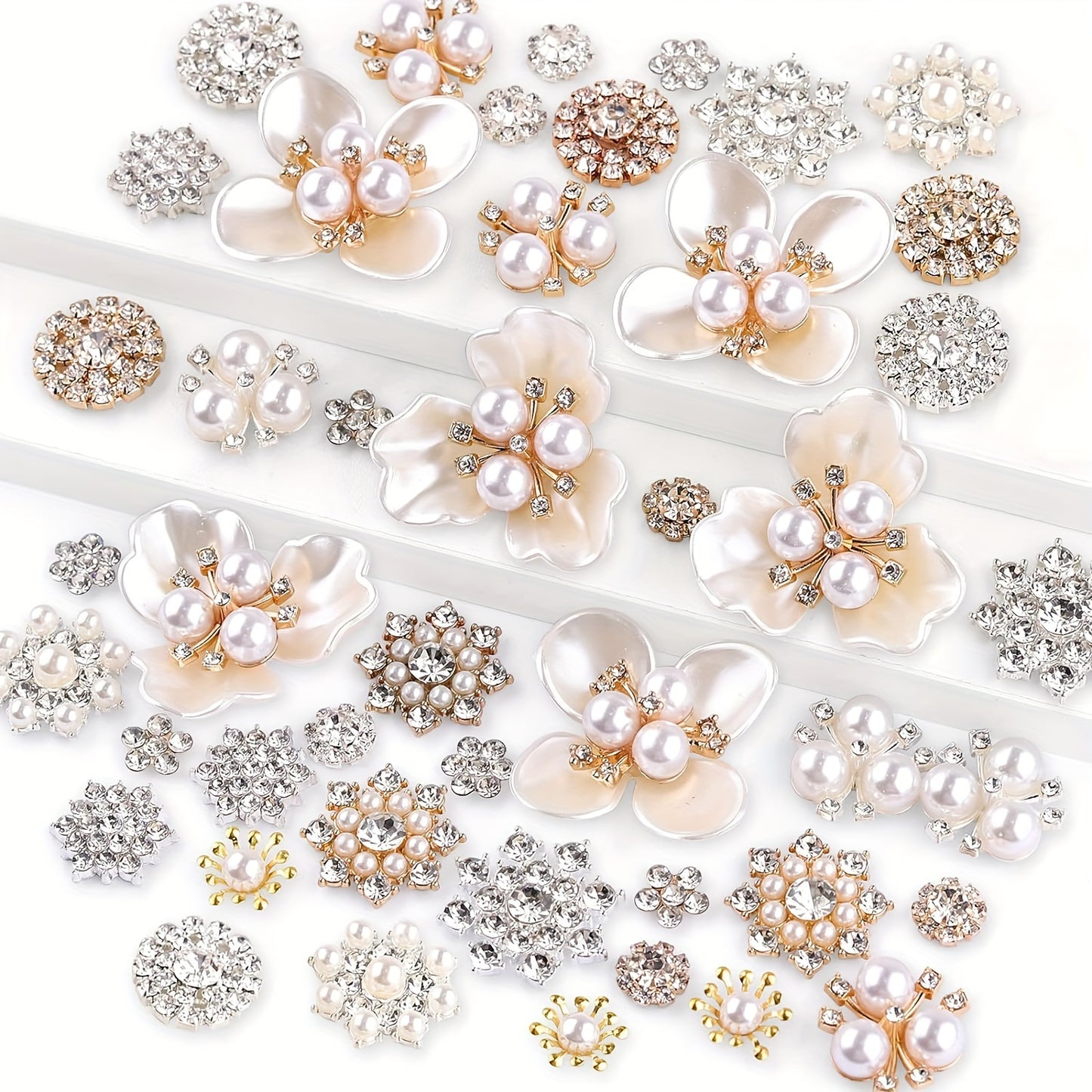 Assorted pearl and rhinestone flower embellishments on a white background