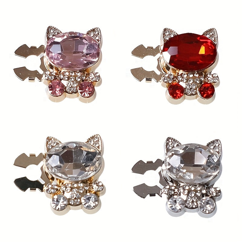 Four cat-shaped jewelry pieces with gemstones on a white background