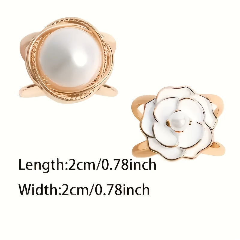 Two gold rings with pearls on a white background