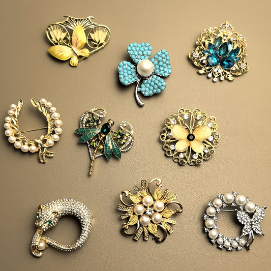 Collection of various jewelry pins on a beige background