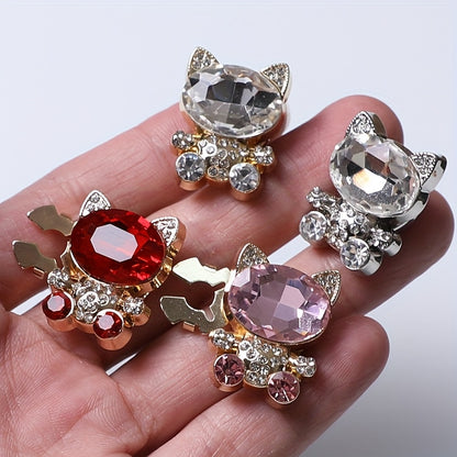 Cat-shaped jewelry with gemstones on a hand against a white background