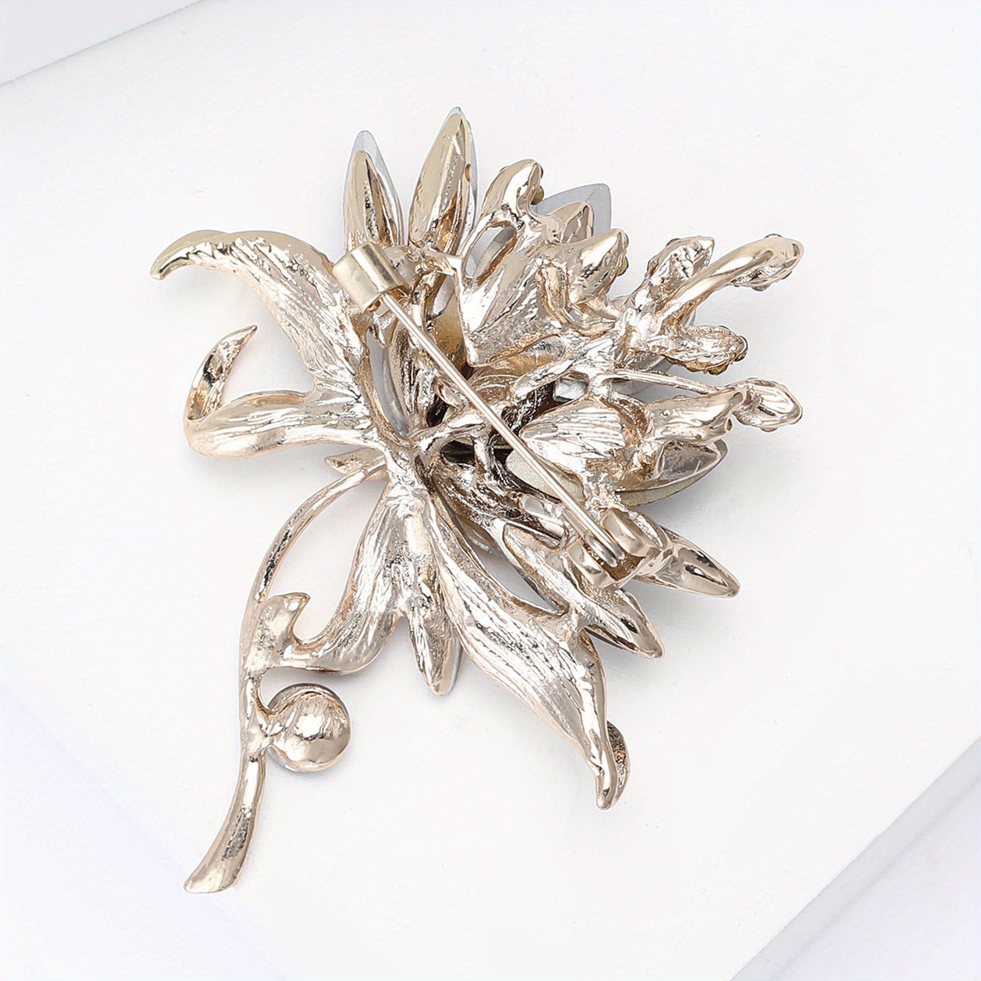 Silver floral brooch on a white background
