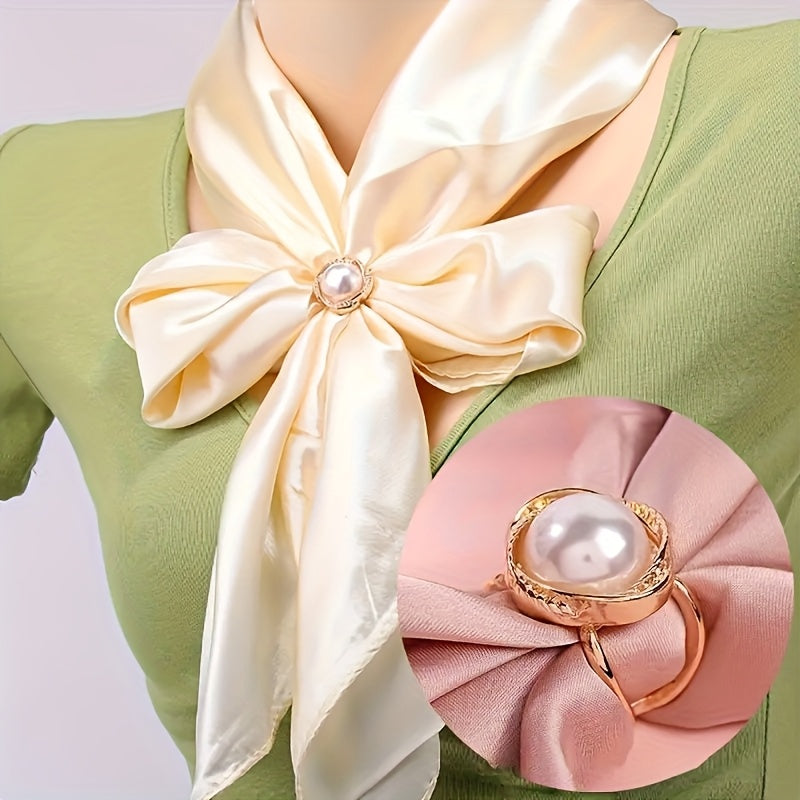Woman wearing a green top with a large cream-colored bow and pink flower accessory on a white background
