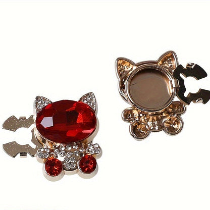 Cat-shaped hair accessories with red gemstones on a white background