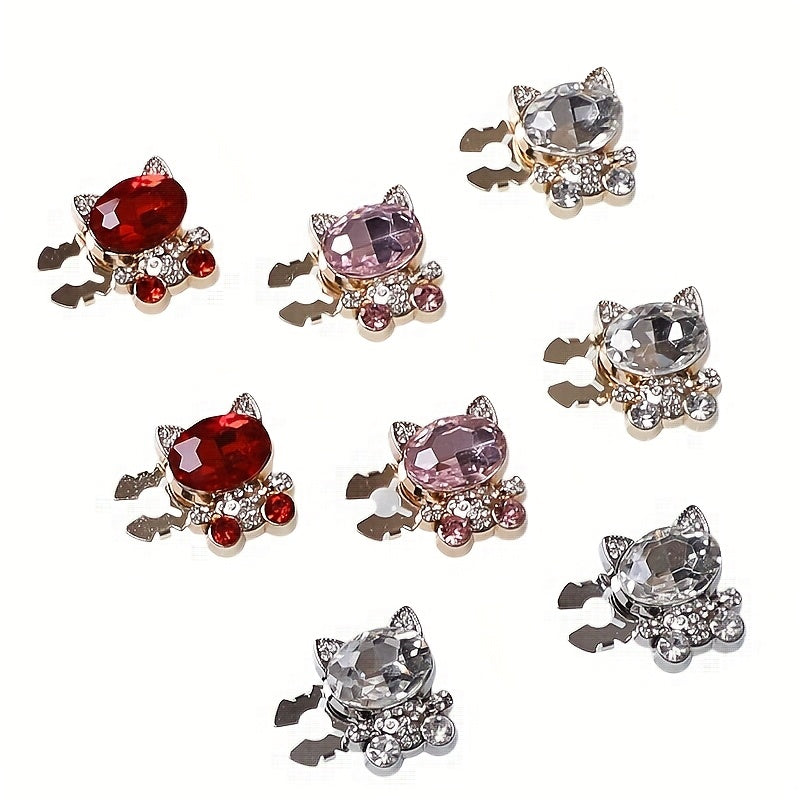 Set of cat-shaped jewelry charms with various gemstone colors on a white background