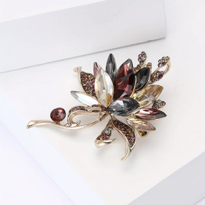 Decorative brooch with gemstones on a white background