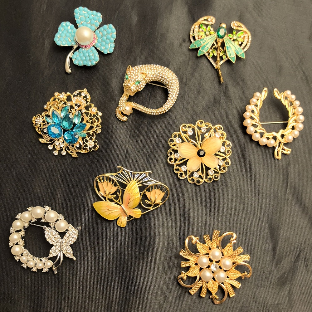Collection of decorative brooches on a dark fabric background