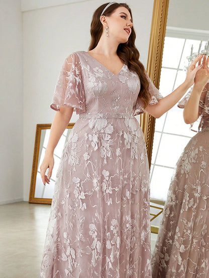 Woman wearing a floral lace dress in a mirror reflection