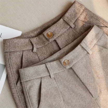 Close-up of a brown textured fabric with buttons on a neutral background