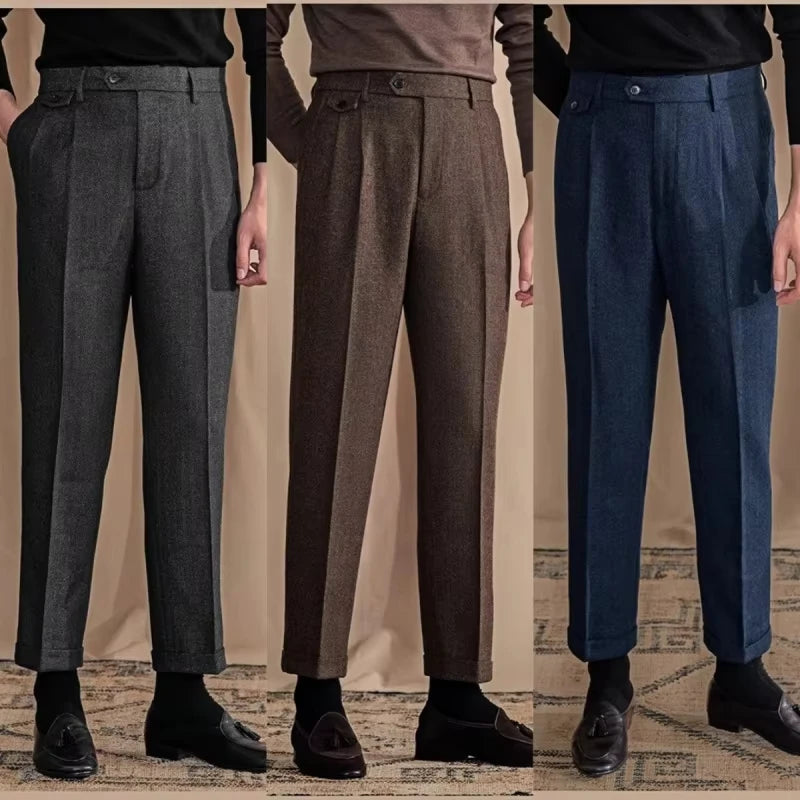Three pairs of men's dress pants in gray, brown, and blue on a neutral background.
