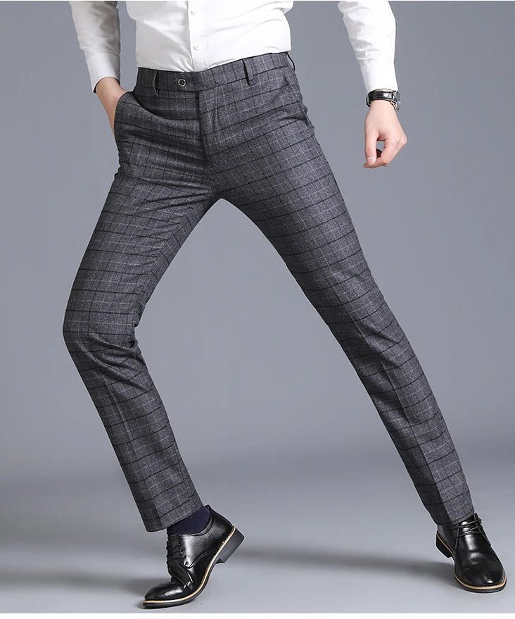Gray checkered pants worn by a person on a gray background