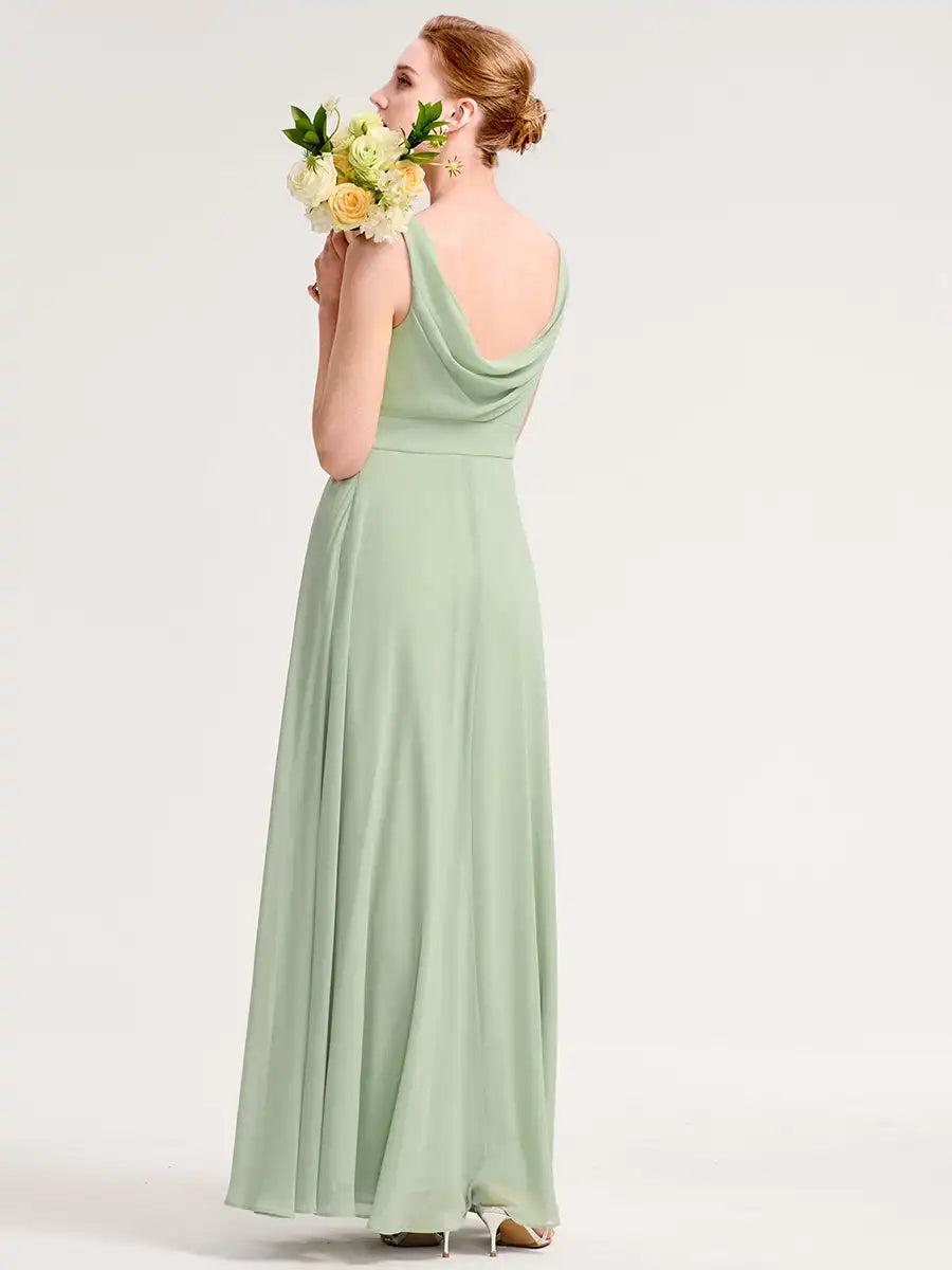 Woman in a light green dress holding flowers against a white background