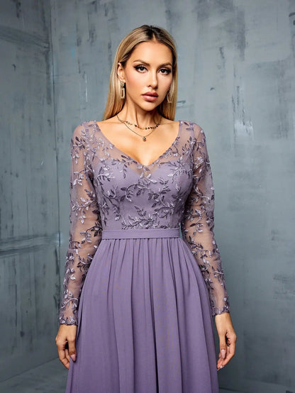 Woman wearing a purple dress with floral lace details against a gray background