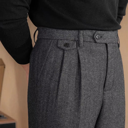 Gray pleated pants worn by a person with a neutral background