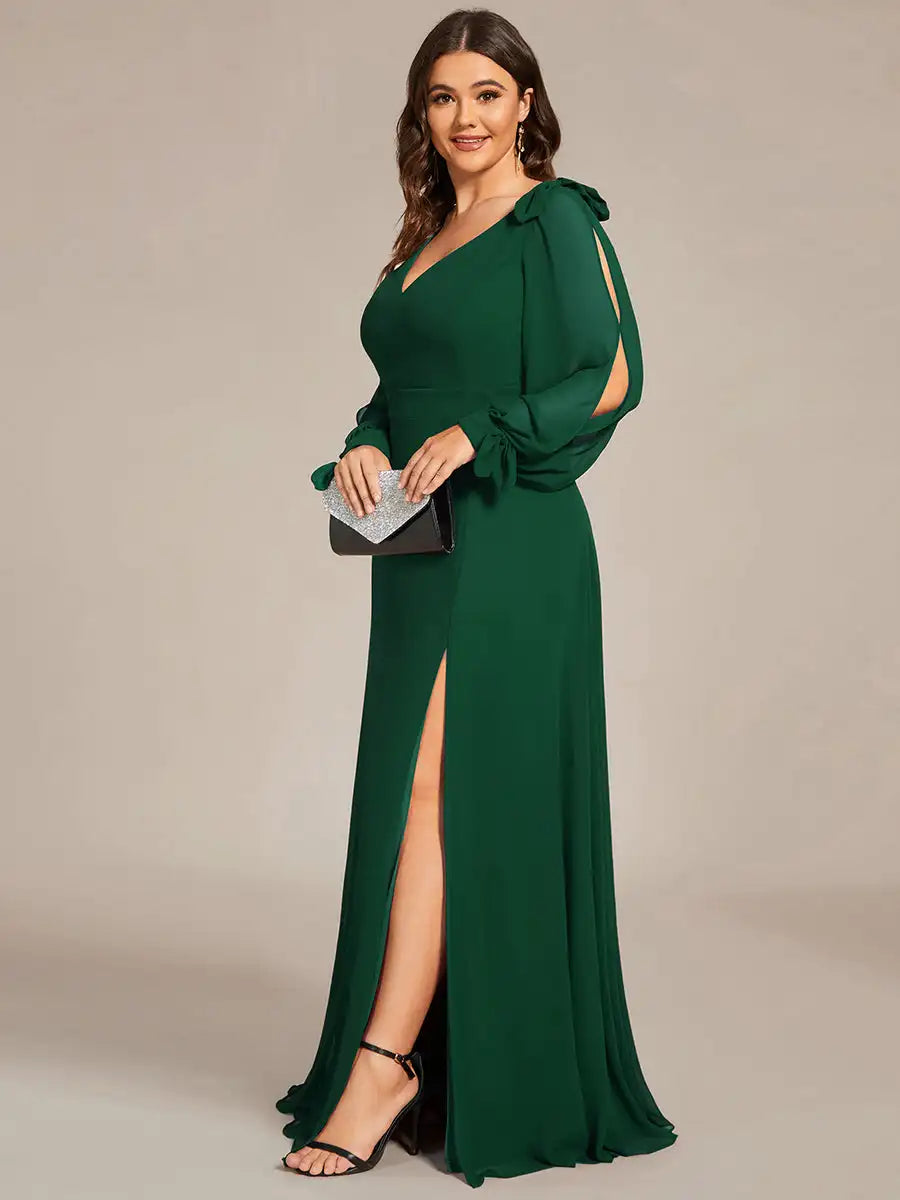 Woman wearing a green evening gown with a slit on a beige background