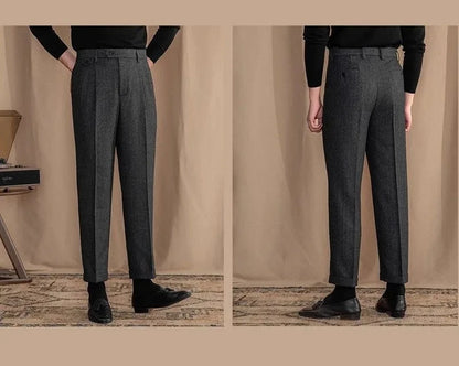 Gray trousers worn by a person on a beige background