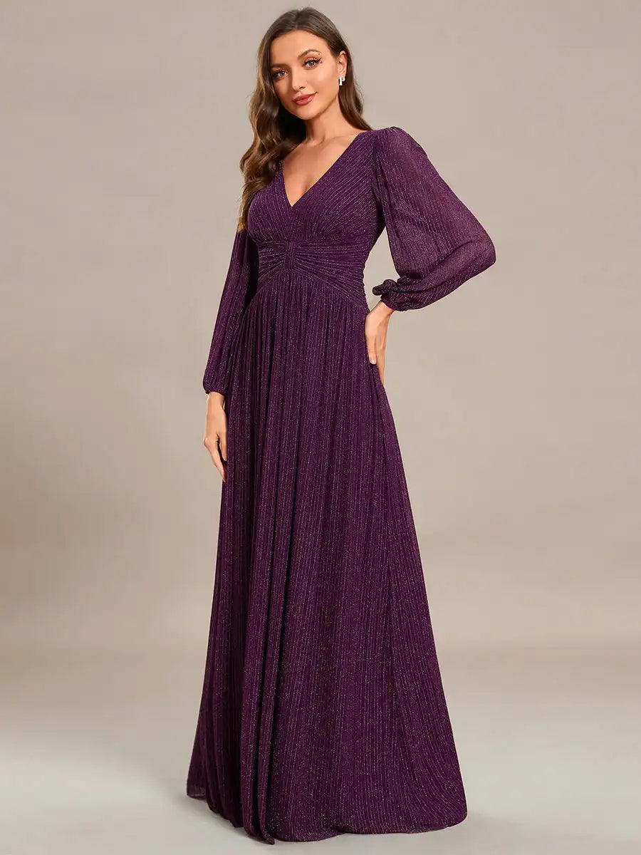 Woman wearing a long purple dress with puffed sleeves on a plain background