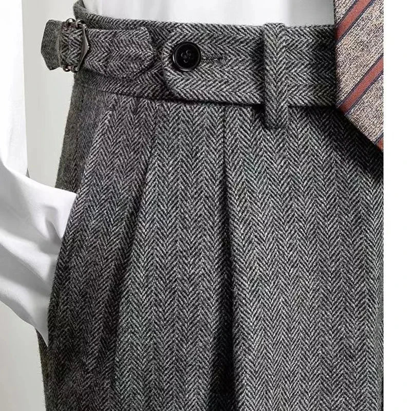 Gray herringbone patterned skirt with a belt and white shirt on a light gray background