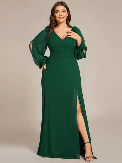 Woman wearing a green evening gown with long sleeves and a high slit on a beige background