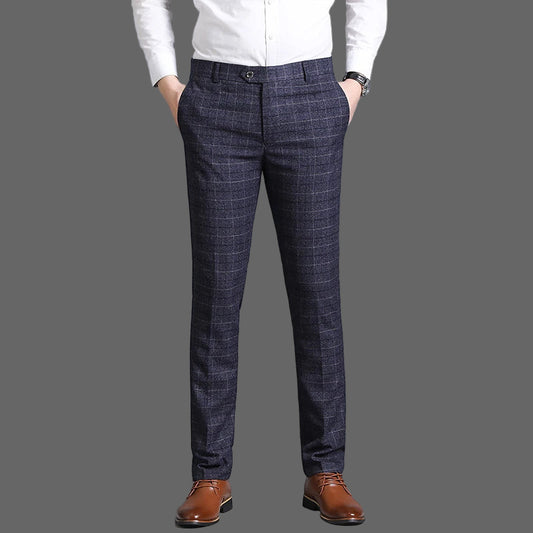 Person wearing dark plaid pants and a white shirt on a gray background