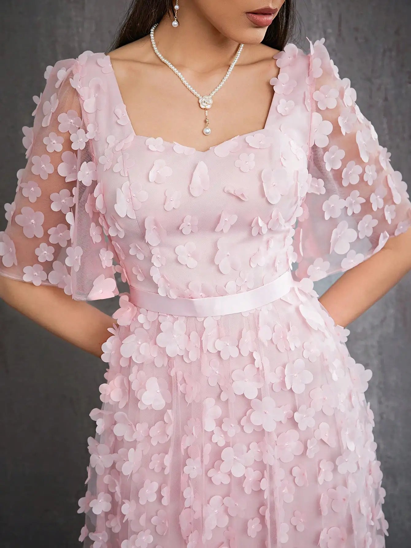 Pink floral dress with a gray background