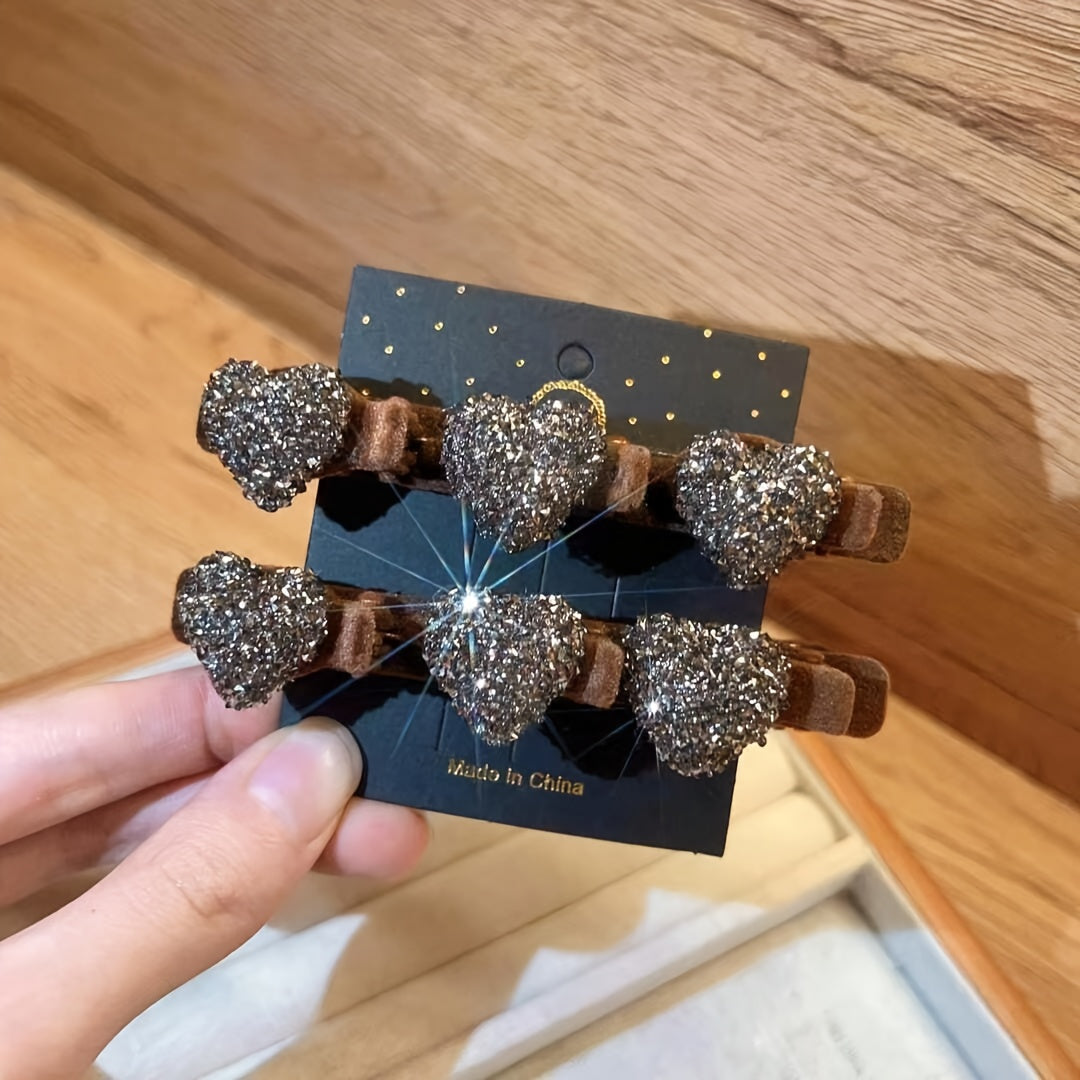Heart-shaped hair clips on a card held by a hand against a wooden background