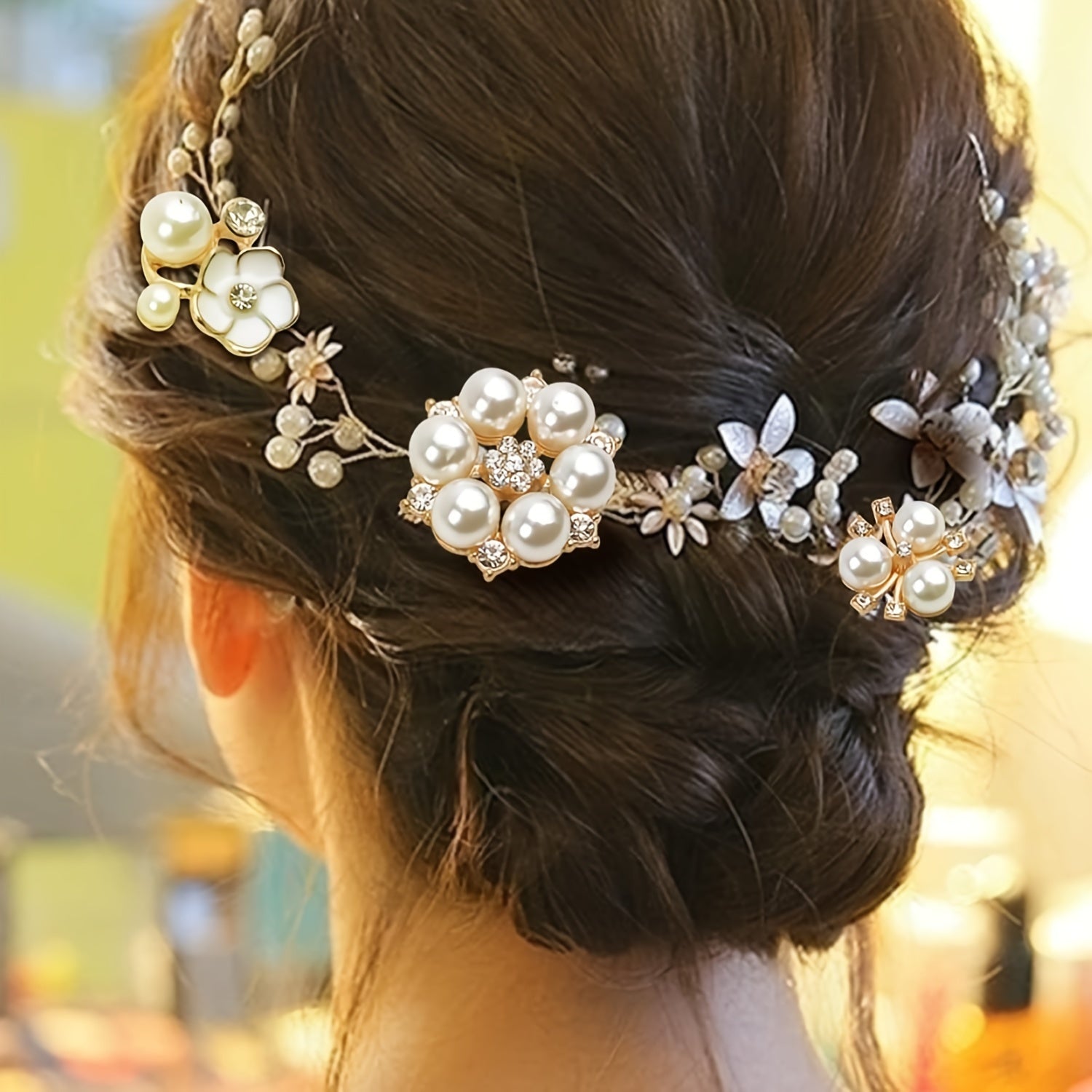 Pearl and floral hair accessory on a bun with a blurred background