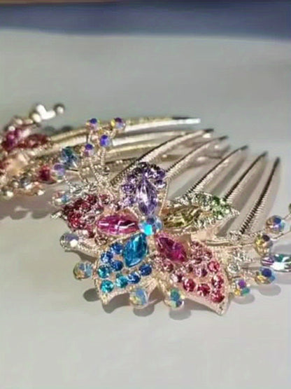 Decorative hair comb with colorful gemstones on a light background